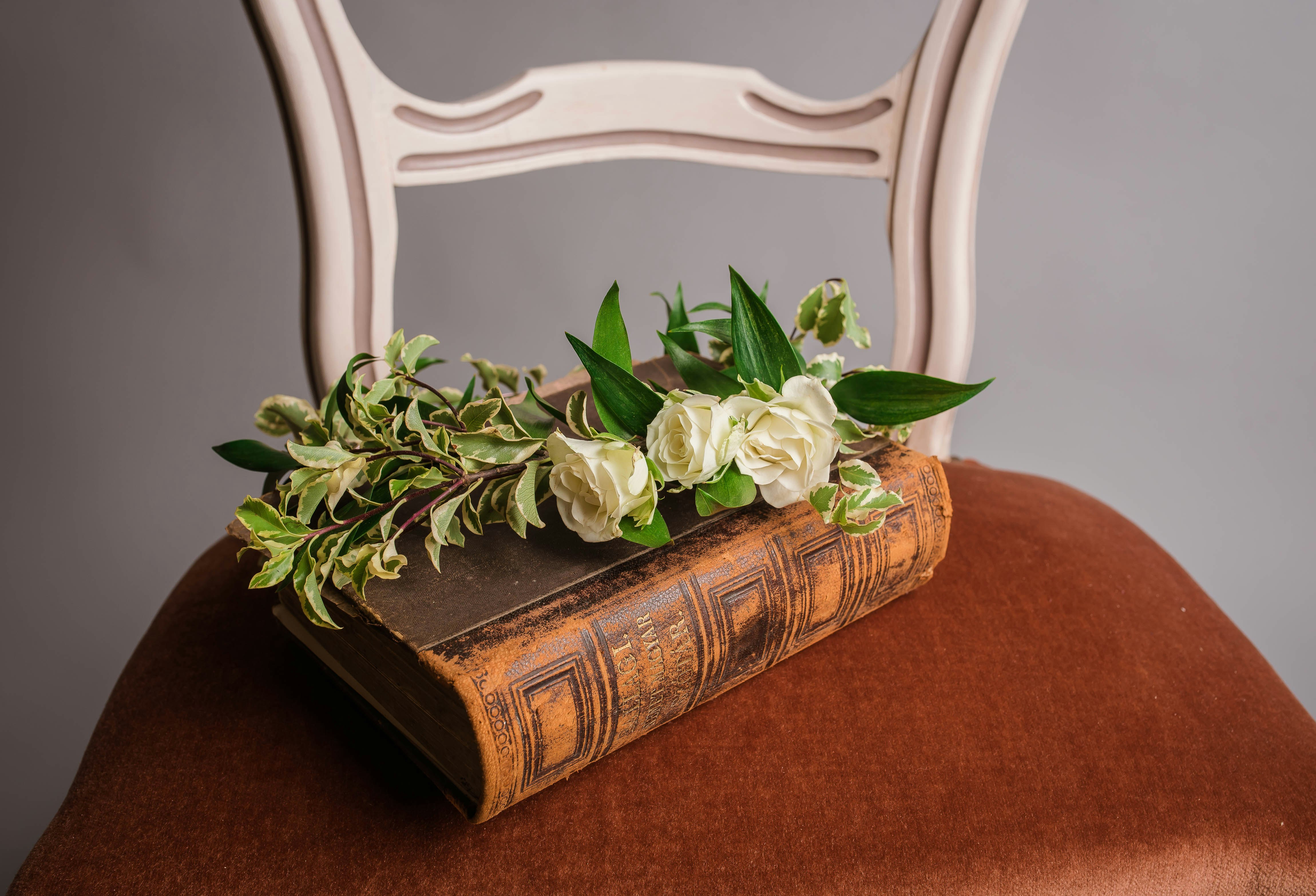 white roses on brown book